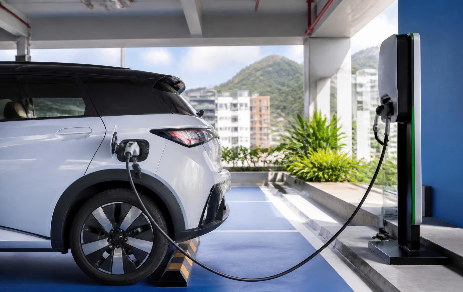 Vehículo eléctrico cargando en un parqueadero moderno